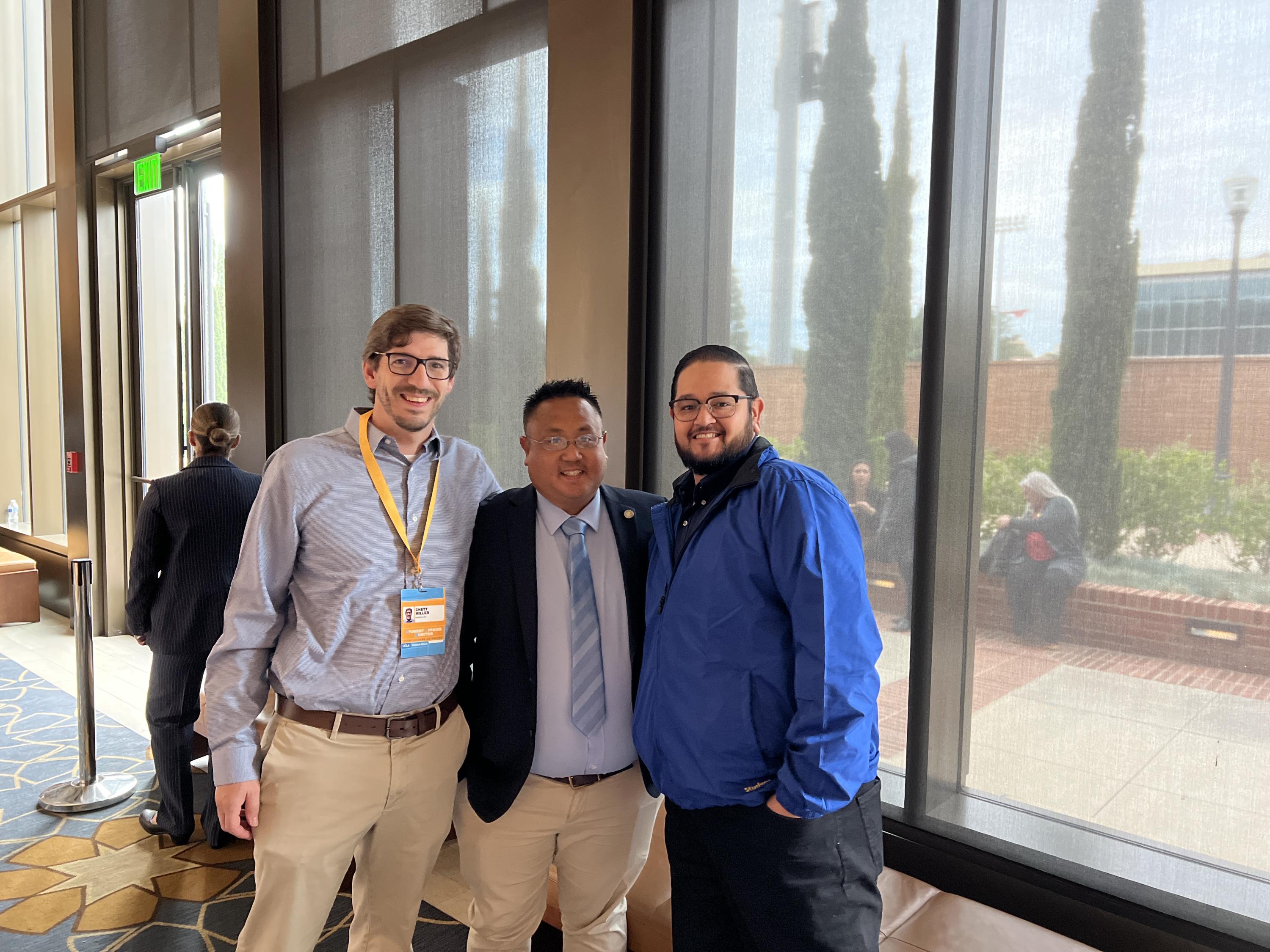 Picture of three Student Affairs staff members serving as SAMs for the UC Regents Meeting in the Luskin Conference Center.